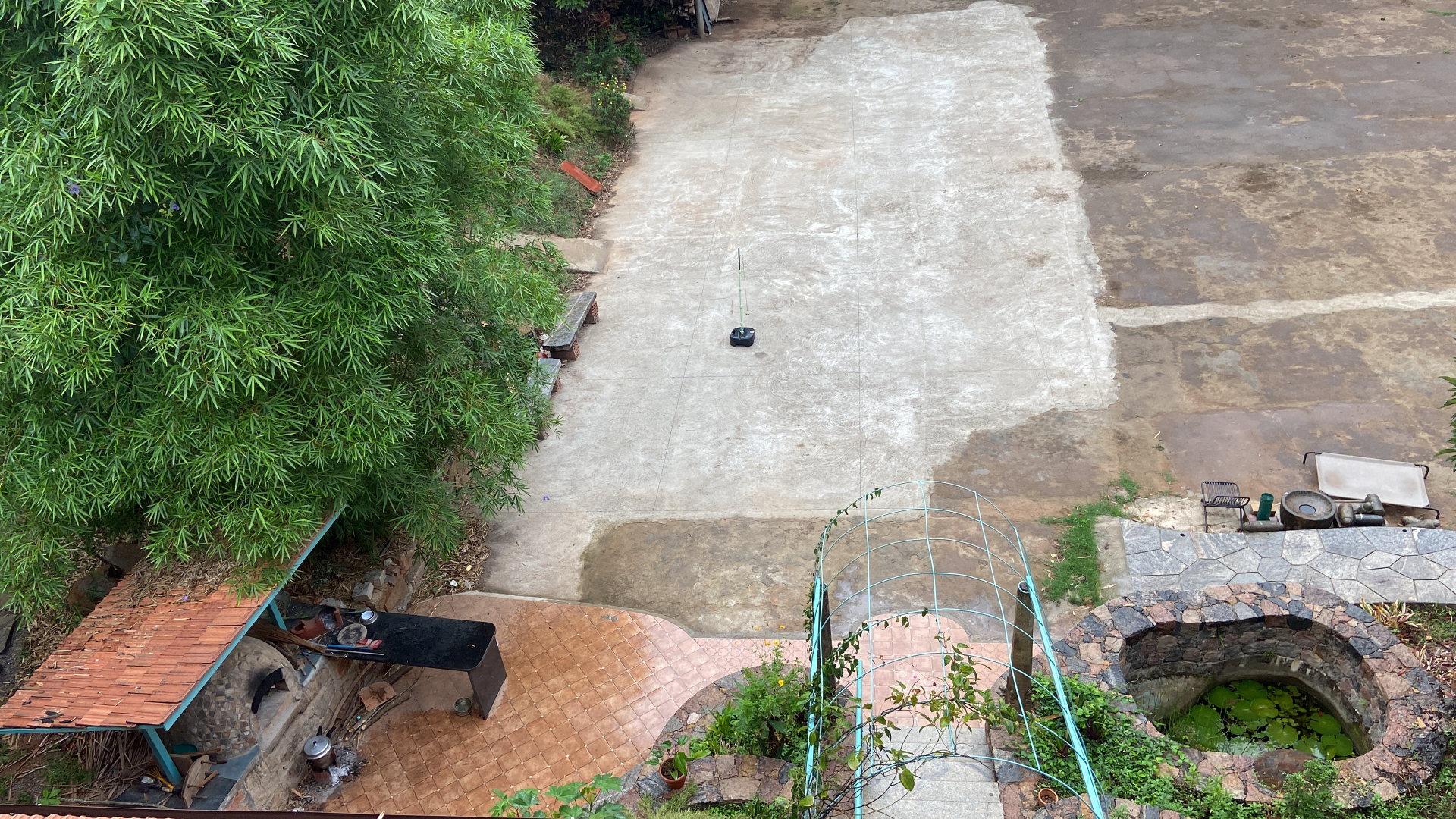 Outdoor courtyard with bamboo, well and skate ground