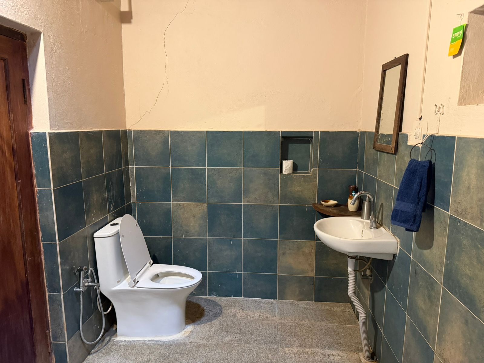 Tiled bathroom with toilet and basin
