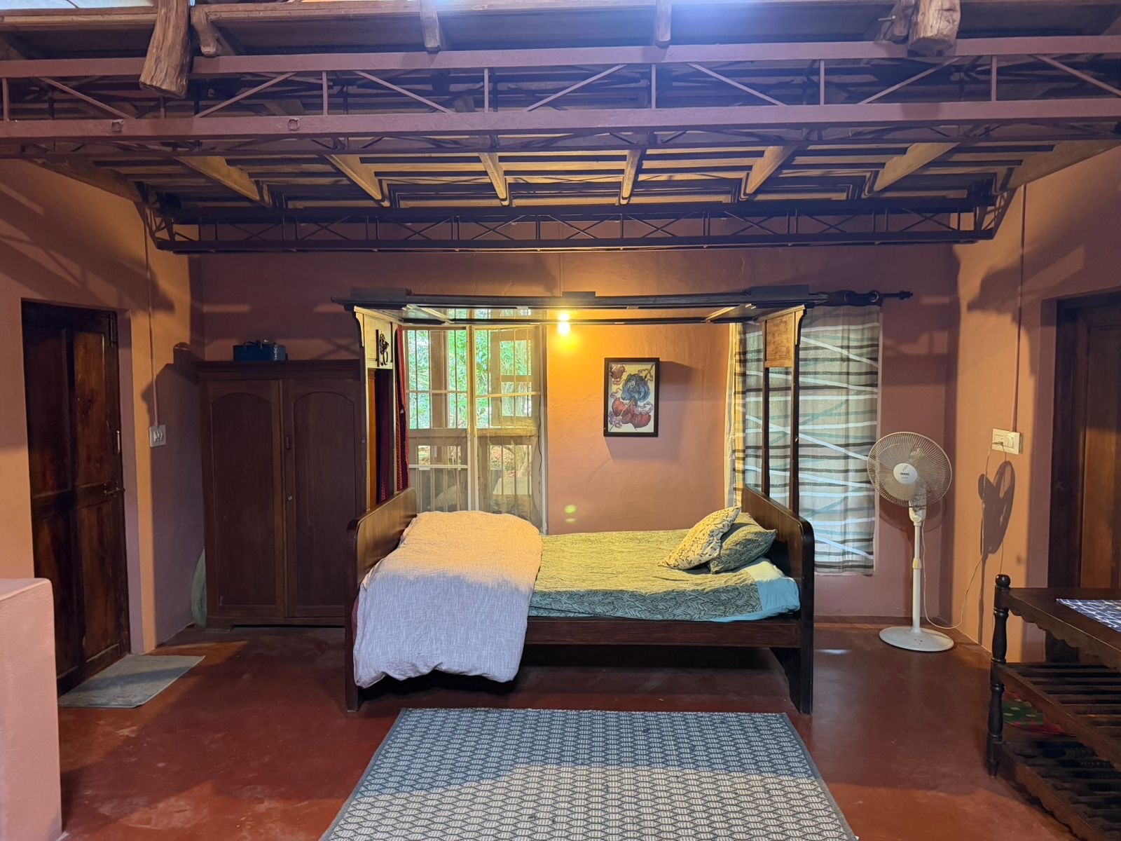 Cosy bedroom with wooden bed and forest view