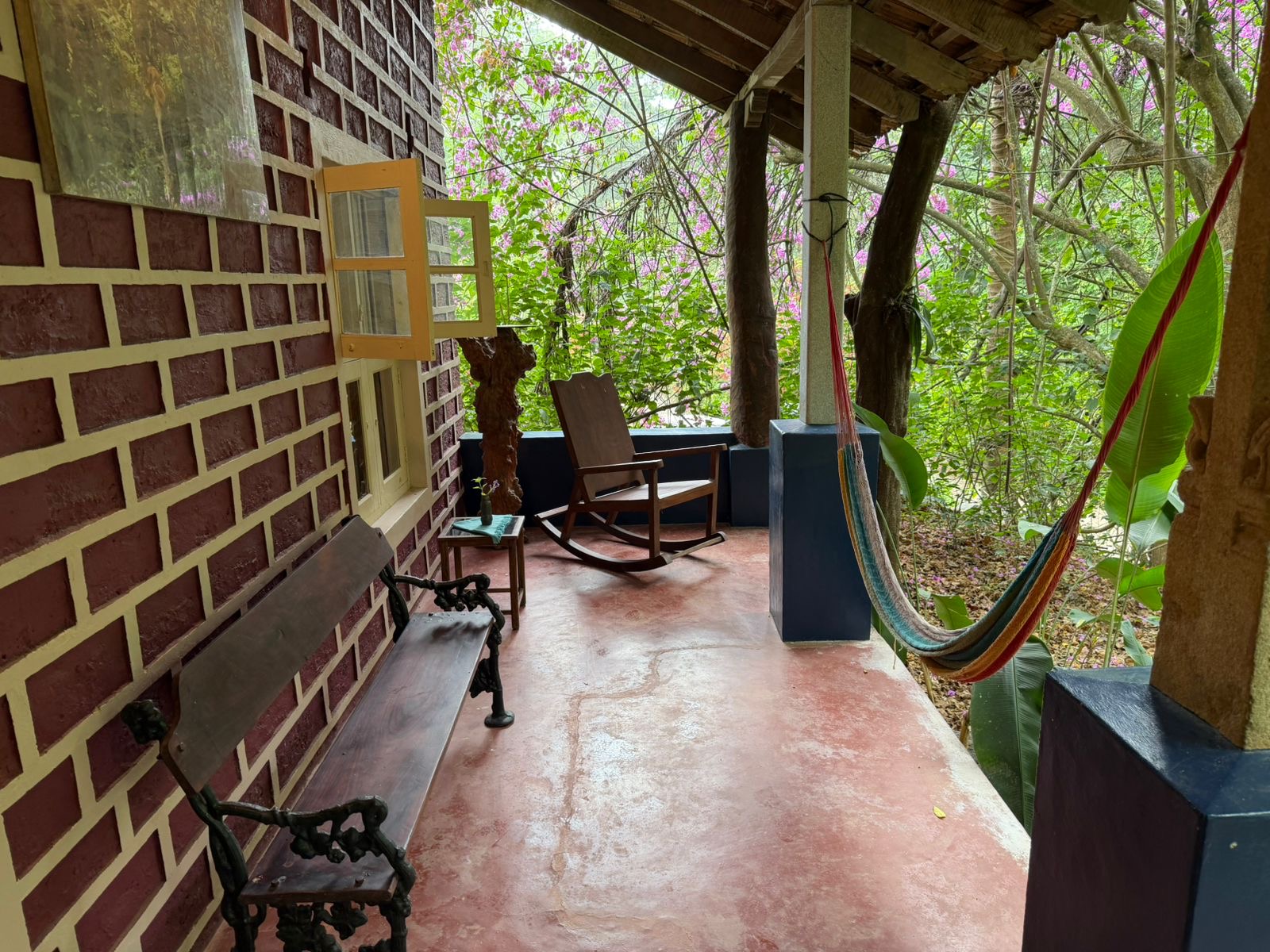 Shaded brick porch with rocking chair and hammock