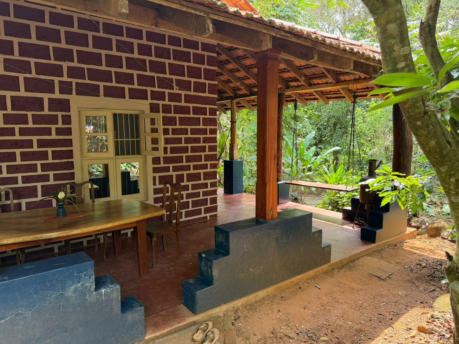 Outdoor dining area beside the brick cottage