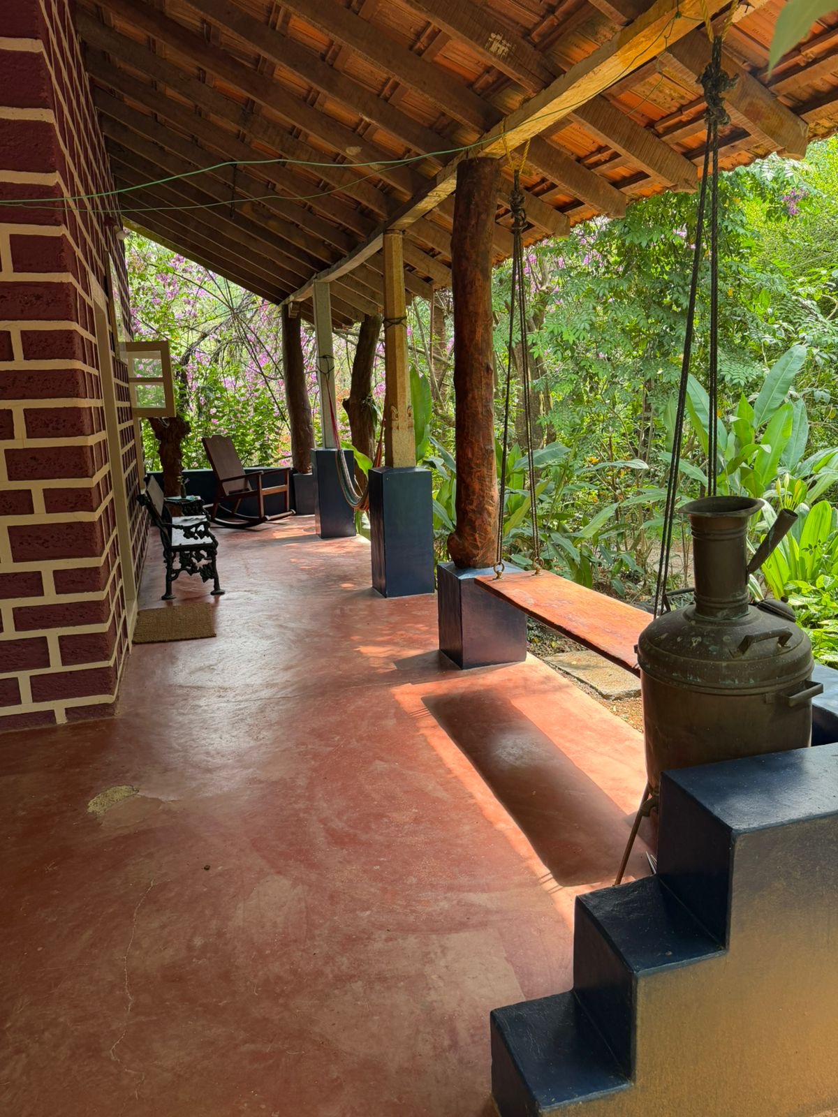 Long porch with swing bench and forest view